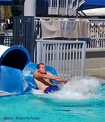 sliding into pool and making a splash