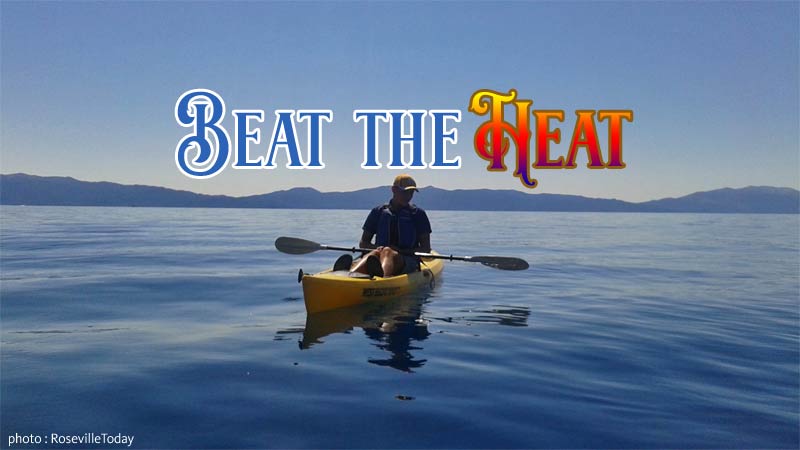 kayaker on an empty Lake Tahoe surrounded by mountains