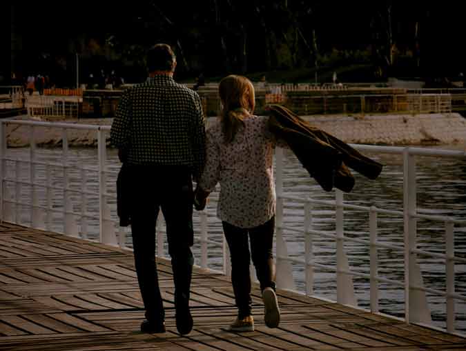 couple walking on pier
