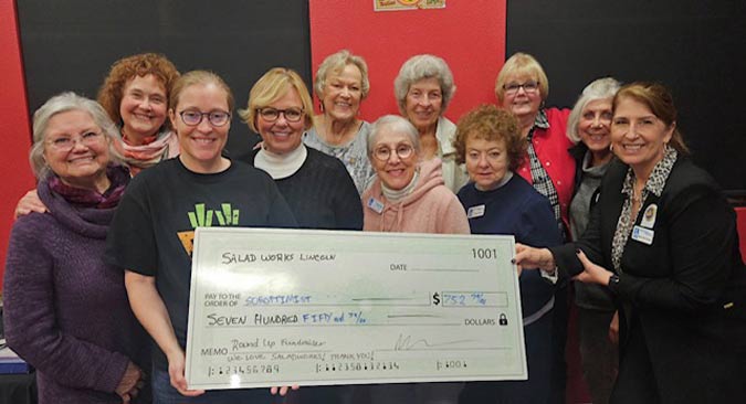 Soroptimists of Lincoln receiving business check