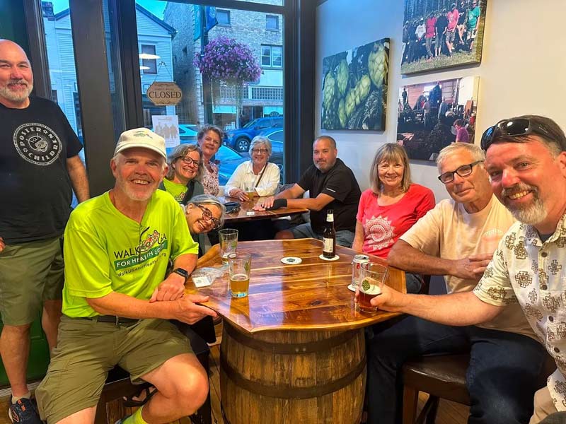 Dr Dennis Godby shares a break with locals during his Walk Across America