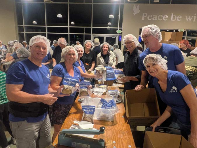 cheerful volunteers in Rocklin pack meals for hungry children